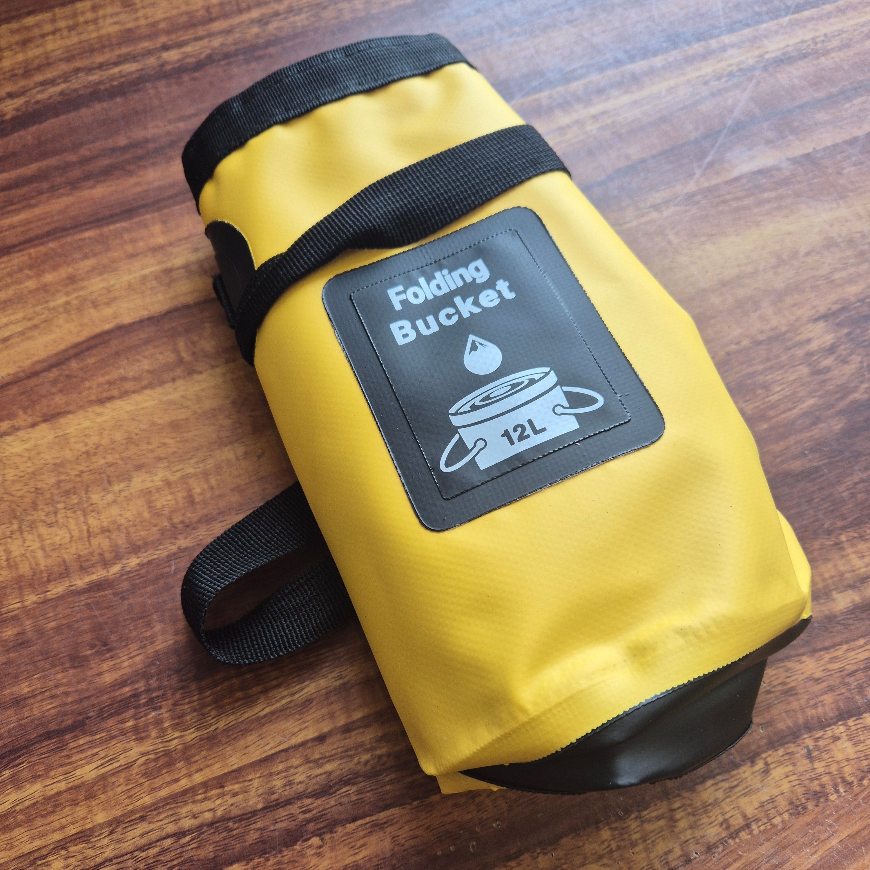 Yellow waterproof bag with a label on a wooden surface
